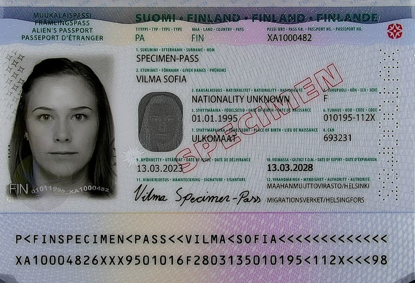 The personal data page of an alien’s passport issued by Finland (a specimen). On the left, there is a black-and-white passport photo of the passport holder.