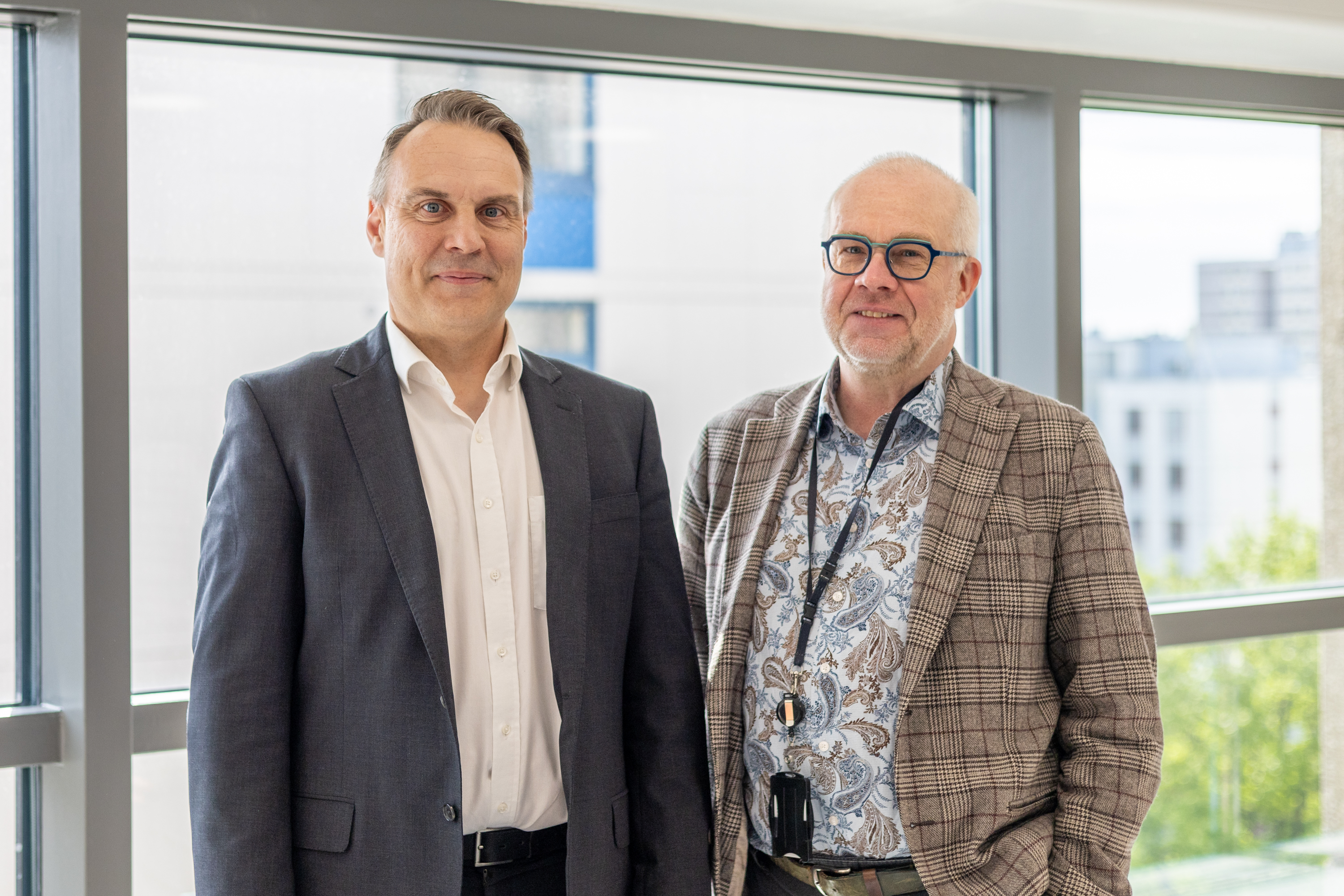 Ilkka Haahtela and Markus Sovala are standing side by side in front of the camera.